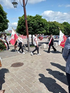 Na zdjęciu znajdują się uczniowie klasy ósmej niosący sztandar z symbolami Polski